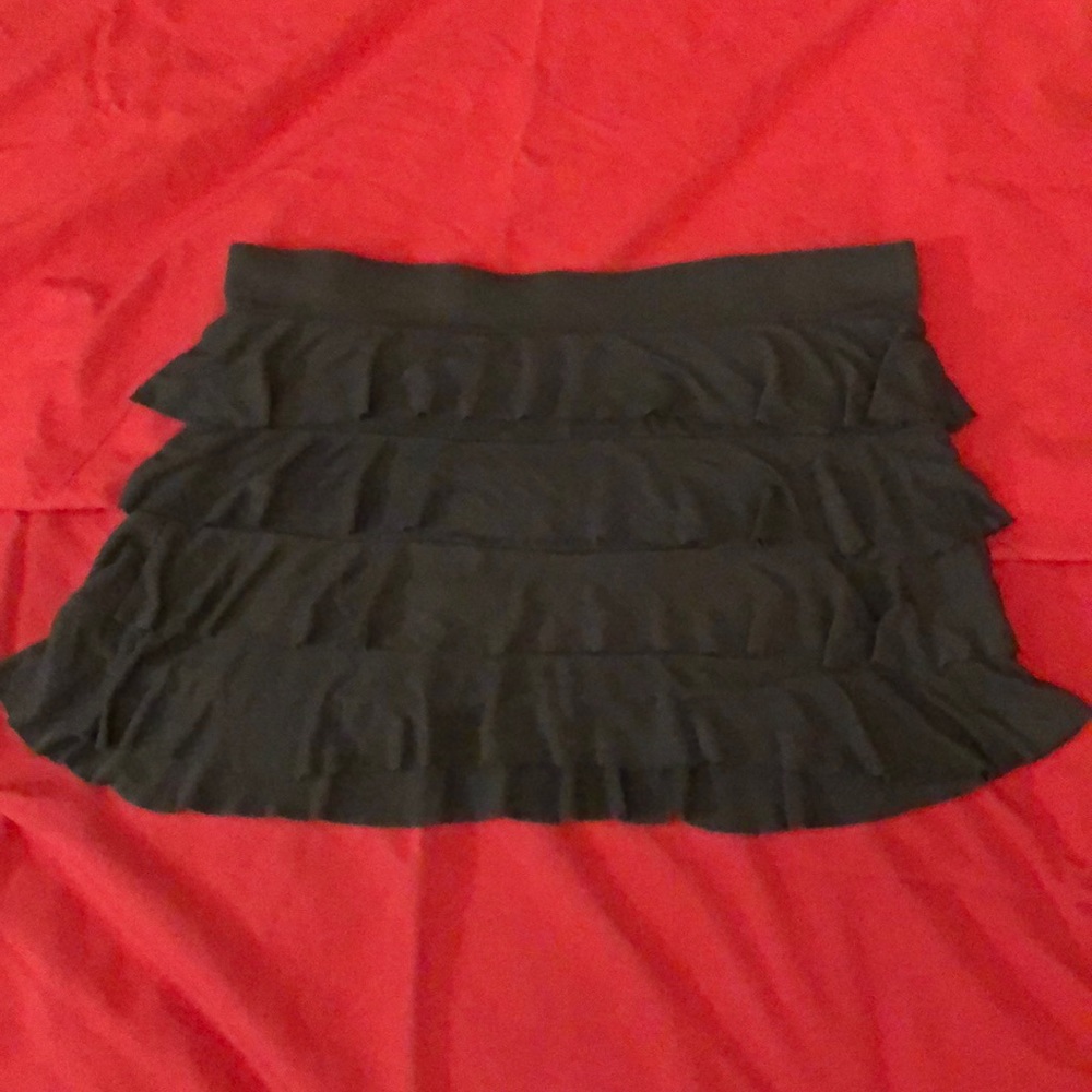 A-line miniskirt. T-shirt material with ruffles.